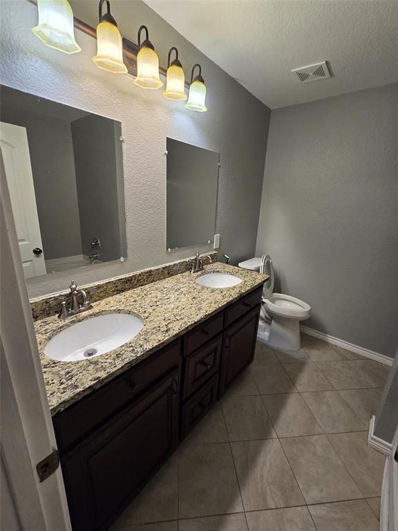 700 White Fields Way Arlington, TX 76002 - Photo 20 of 31 a bathroom with a granite countertop sink and a mirror