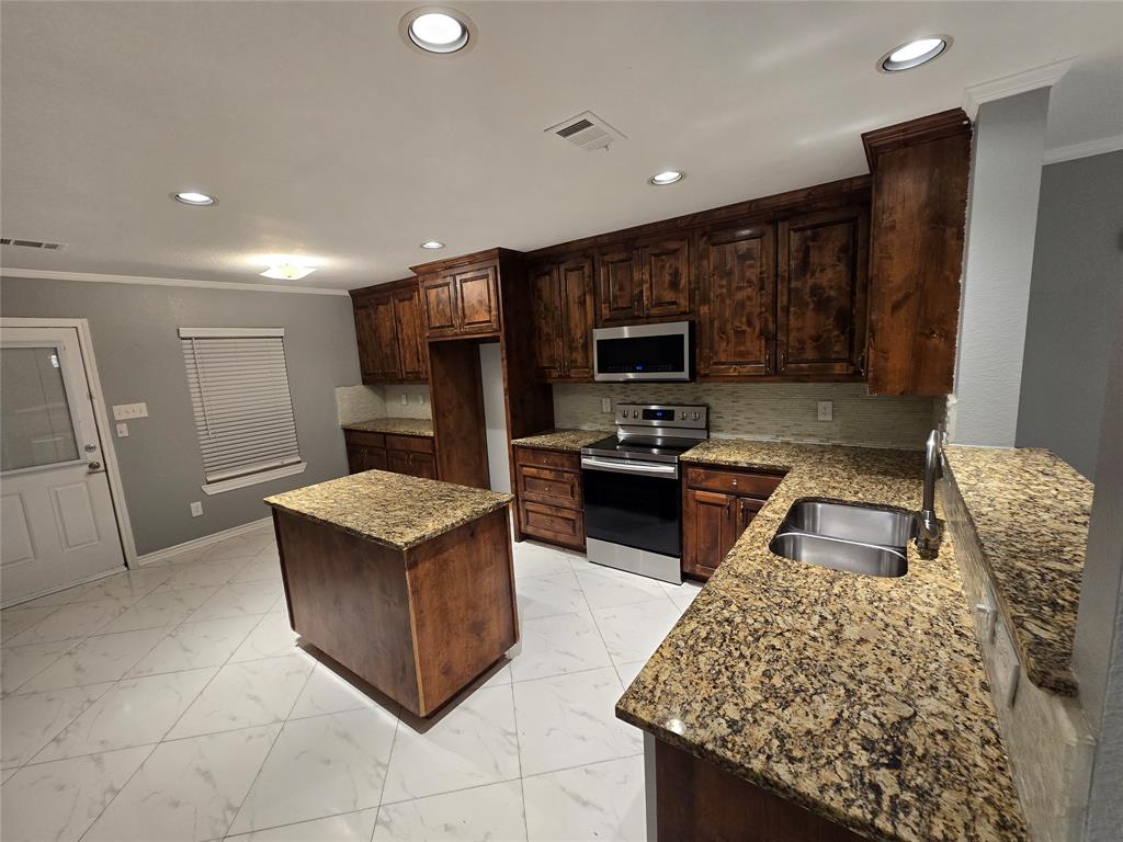 700 White Fields Way Arlington, TX 76002 - Photo 2 of 31 a kitchen with stainless steel appliances granite countertop a refrigerator stove microwave and sink
