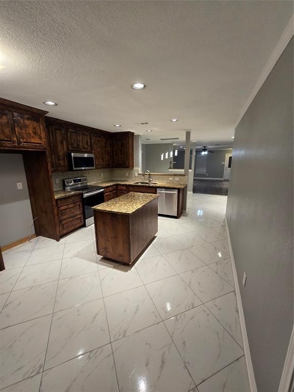 700 White Fields Way Arlington, TX 76002 - Photo 9 of 31 a kitchen with stainless steel appliances a stove a sink a microwave and a refrigerator
