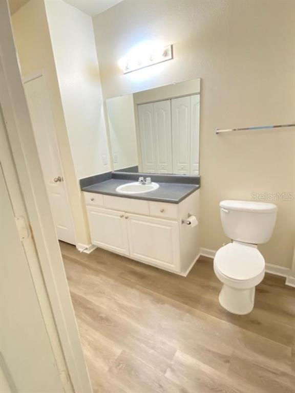 8849 Villa View Circle, Unit 203 Orlando, FL 32821 - Photo 10 of 12 a bathroom with a sink a toilet and a mirror