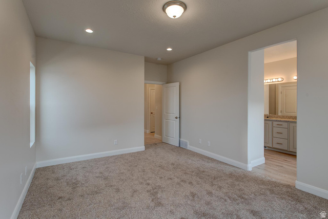 1512 West 600 North, Unit O4A Mapleton, UT 84664 - Photo 11 of 24 Unfurnished bedroom with light colored carpet, recessed lighting, and ensuite bathroom