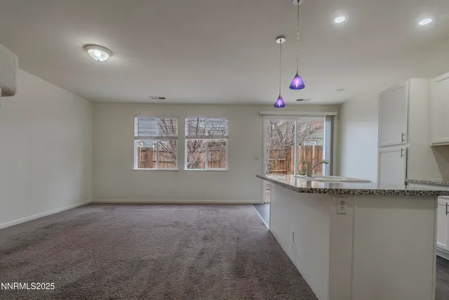 a kitchen with stainless steel appliances granite countertop a sink and cabinets