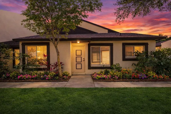 a front view of a house with a yard