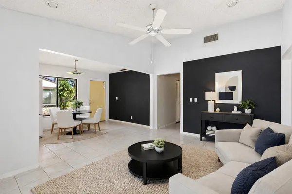 a living room with furniture and a mirror