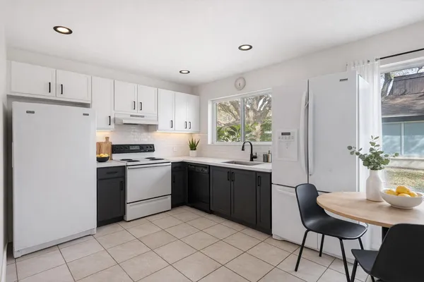 a kitchen with a sink cabinets and window