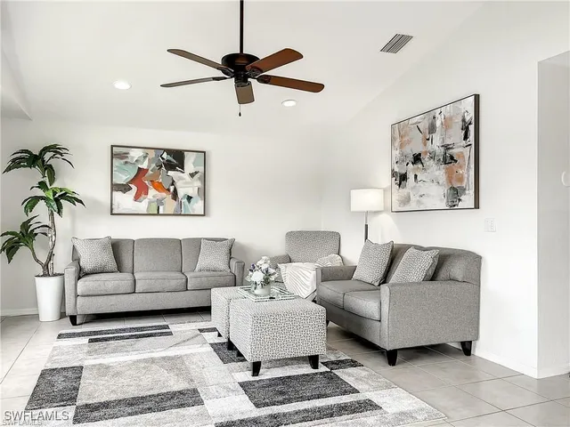a living room with furniture and a rug