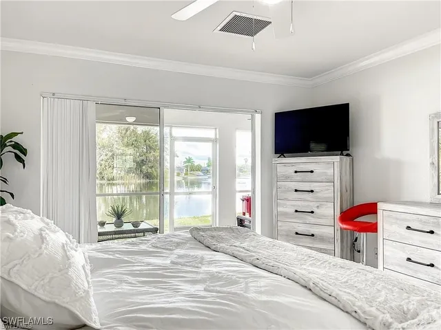 a bedroom with a bed and flat screen tv