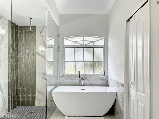 a spacious bathroom with a bathtub and shower