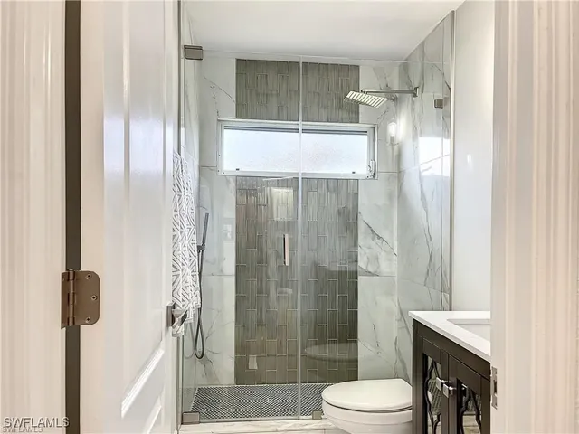 a bathroom with a shower and a toilet