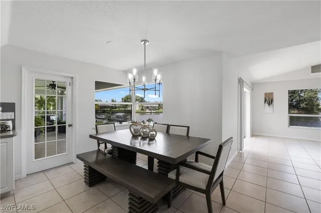 a view of a dining room with furniture wooden floor and chandelier
