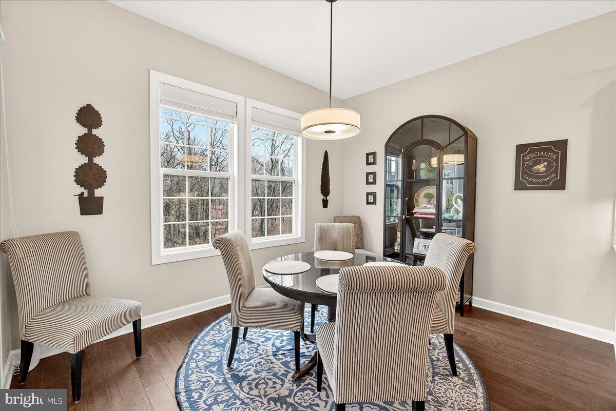 5487 Tallyn Ridge Drive Frederick, MD 21704 - Photo 18 of 80 a view of a dining room with furniture and wooden floor
