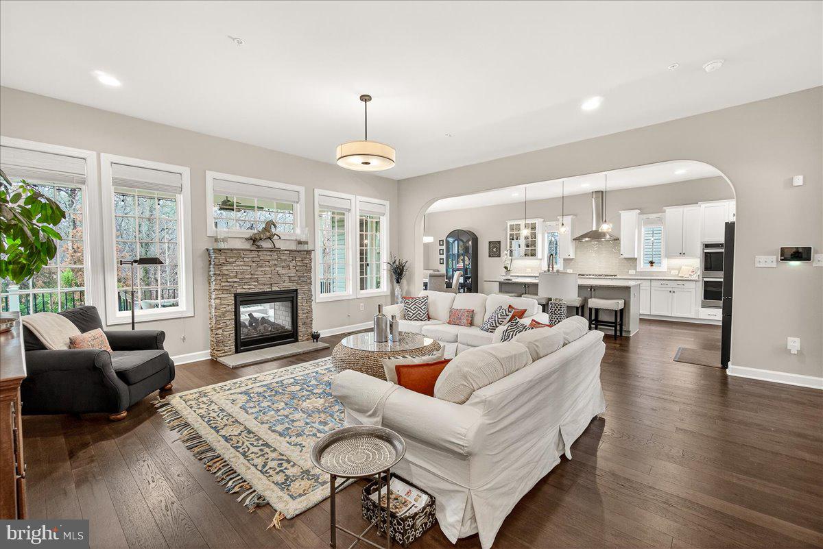5487 Tallyn Ridge Drive Frederick, MD 21704 - Photo 22 of 80 a living room with furniture fireplace and a table