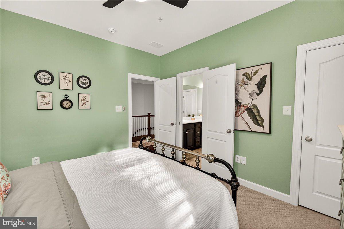 5487 Tallyn Ridge Drive Frederick, MD 21704 - Photo 42 of 80 a bedroom with a bed and a refrigerator