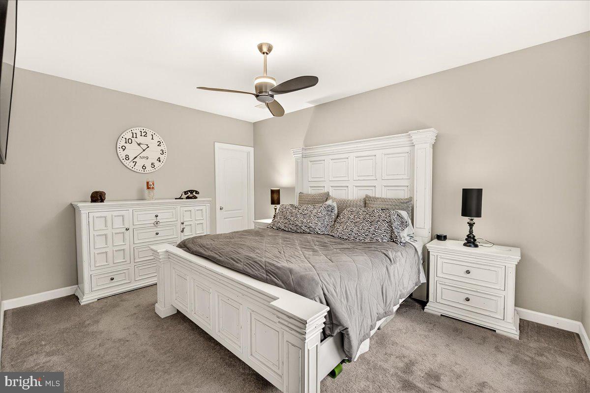 5487 Tallyn Ridge Drive Frederick, MD 21704 - Photo 44 of 80 a spacious bedroom with a bed and a table