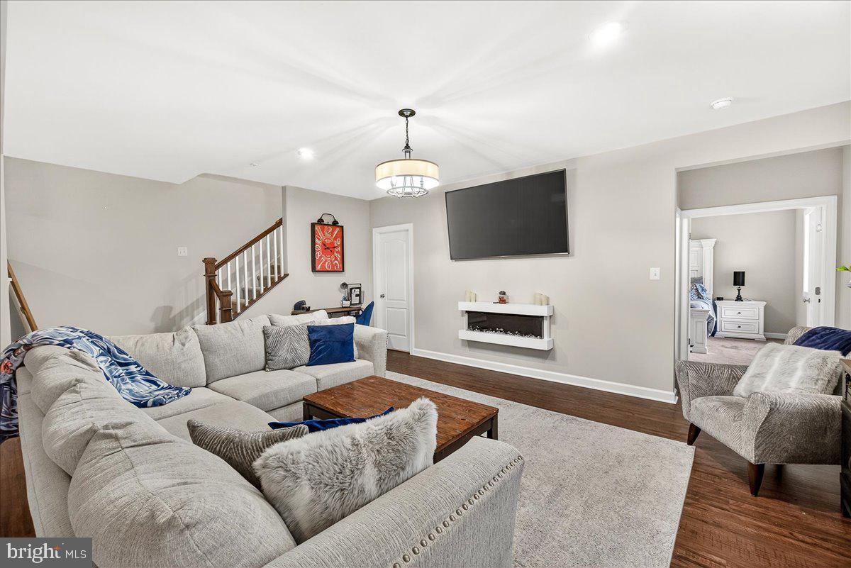 5487 Tallyn Ridge Drive Frederick, MD 21704 - Photo 52 of 80 a living room with furniture a fireplace and a flat screen tv