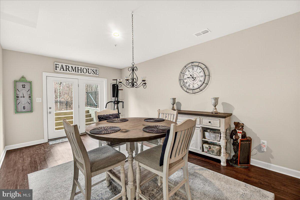 5487 Tallyn Ridge Drive Frederick, MD 21704 - Photo 55 of 80 a view of a dining room with furniture and wooden floor