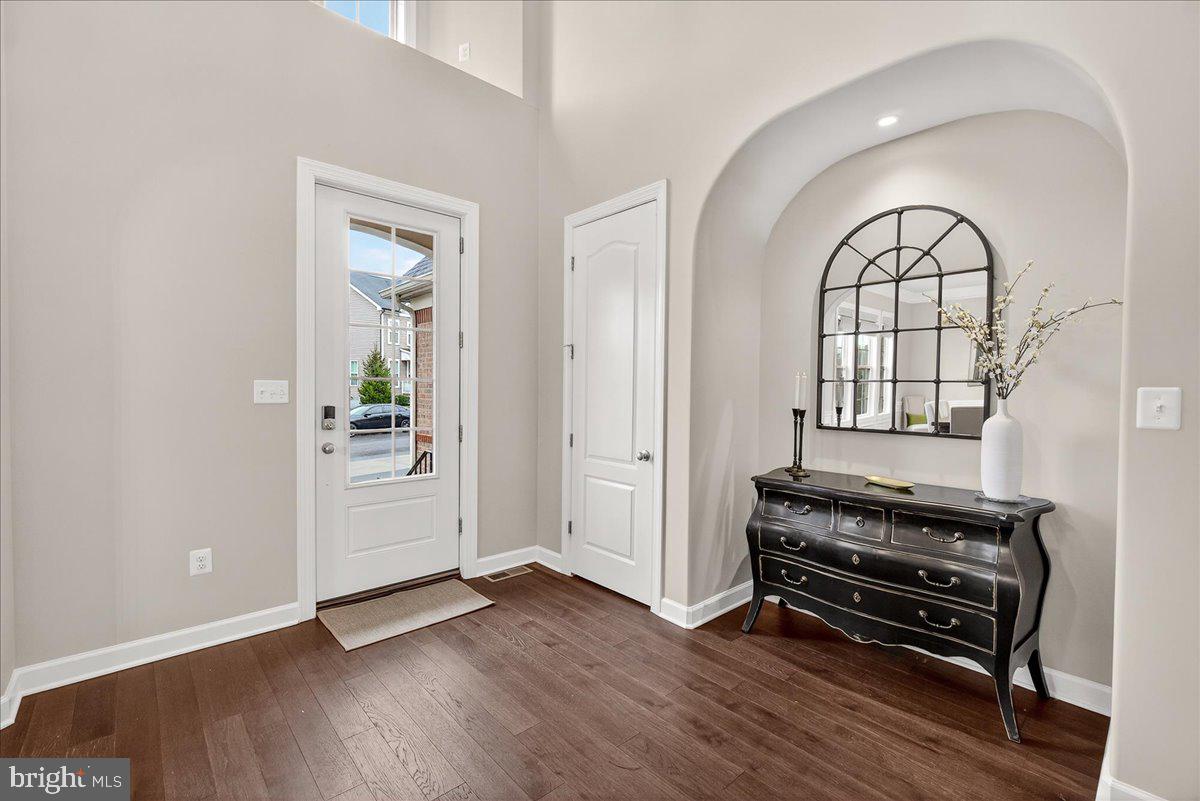 5487 Tallyn Ridge Drive Frederick, MD 21704 - Photo 7 of 80 an empty room with wooden floor a glass door and a window