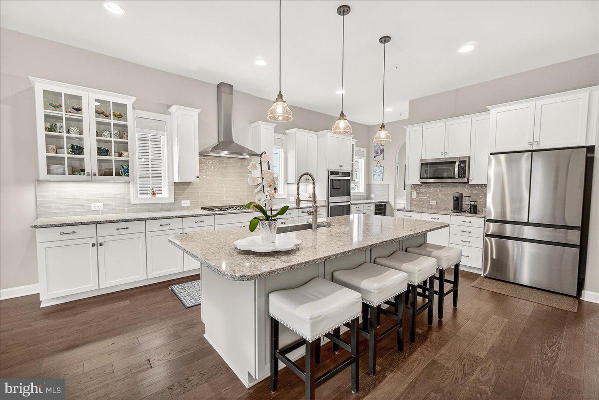 5487 Tallyn Ridge Drive Frederick, MD 21704 - Photo 9 of 80 a large kitchen with kitchen island a center island a sink stainless steel appliances and cabinets