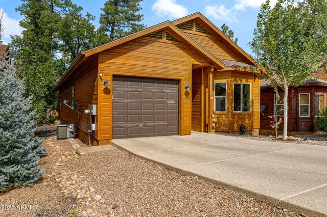 a view of backyard of house with green space