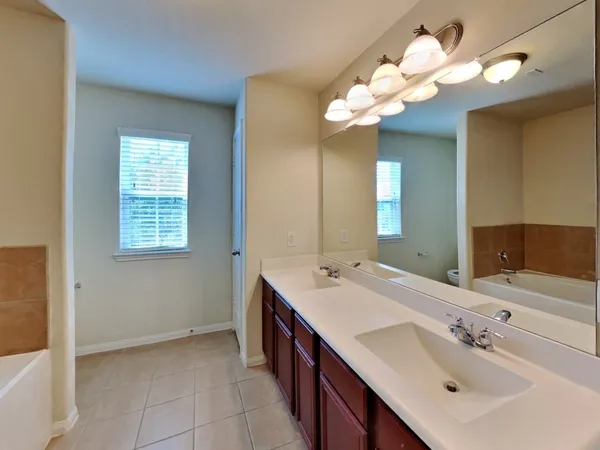 a bathroom with a sink vanity and a mirror