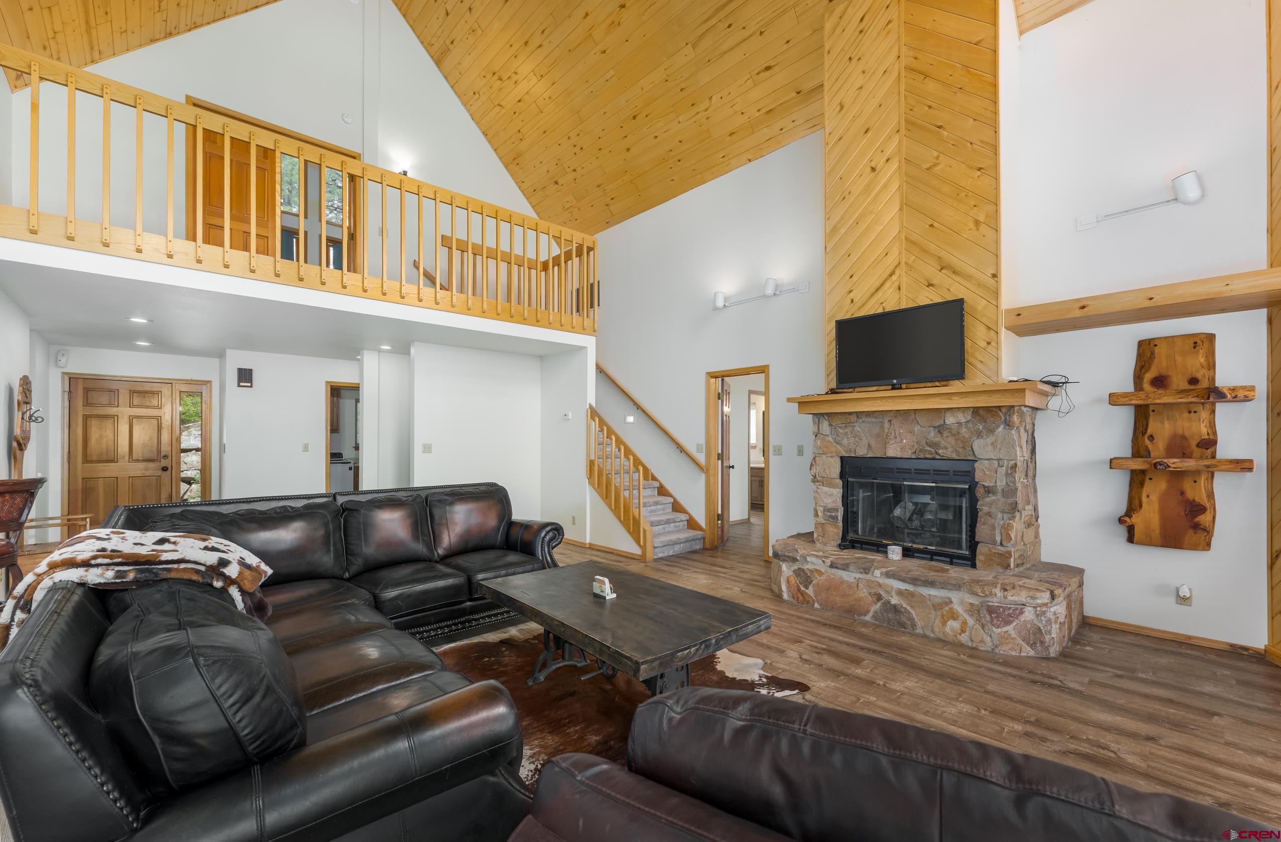 197 Buckhorn Road Bayfield, CO 81122 - Photo 4 of 34 a living room with furniture and a fireplace