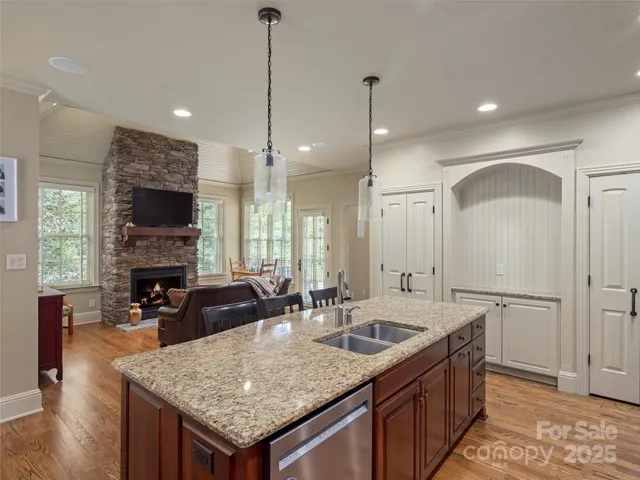 a kitchen with sink stove and refrigerator