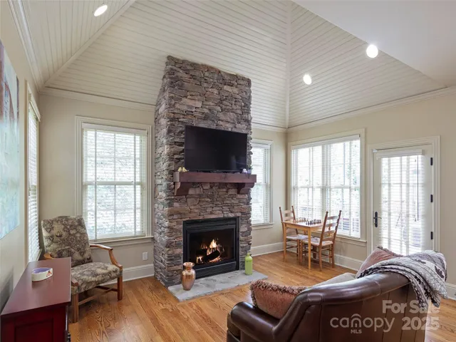 a living room with furniture fireplace and window