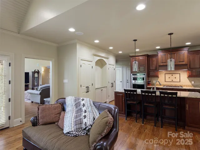 a living room with furniture and kitchen view