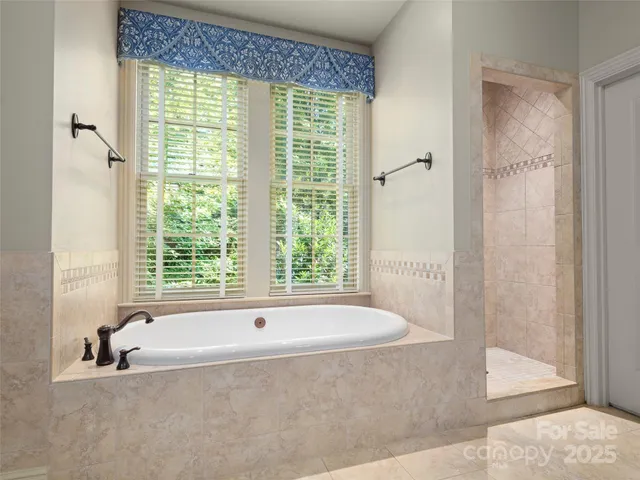 a bath tub sitting in a bathroom next to a window
