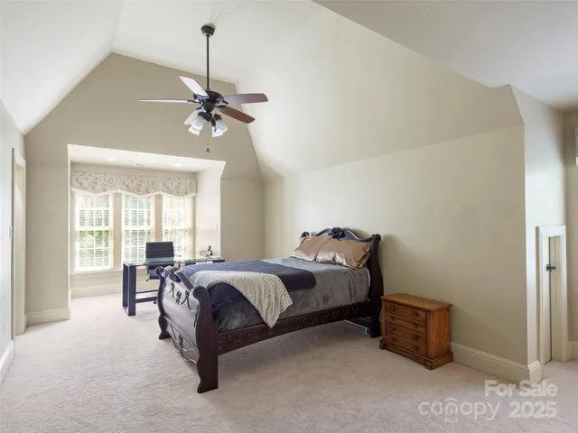 a bed room with a bed and a chandelier