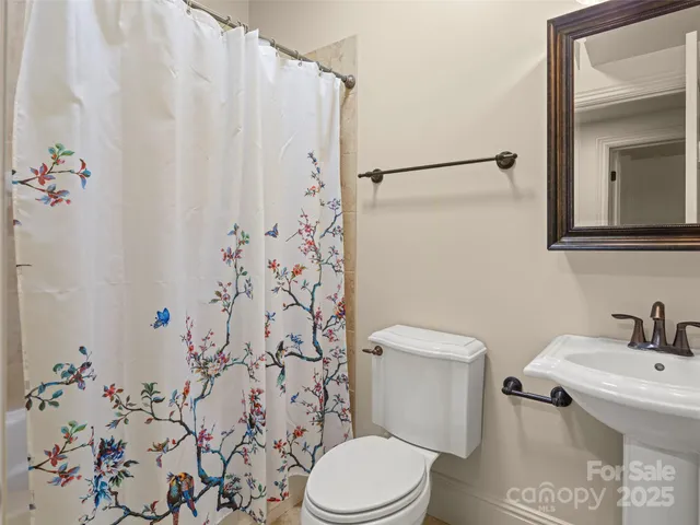 a white toilet sitting next to a bathroom sink