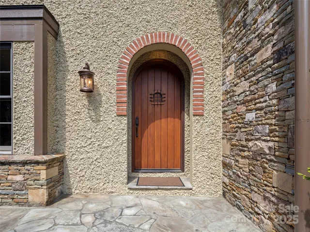 a view of entrance with a wooden door