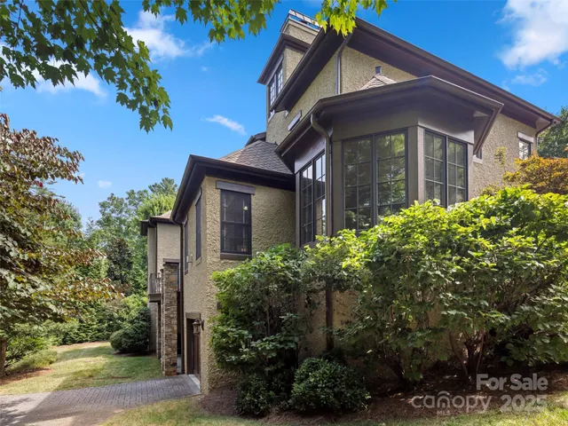 a front view of a house with plants
