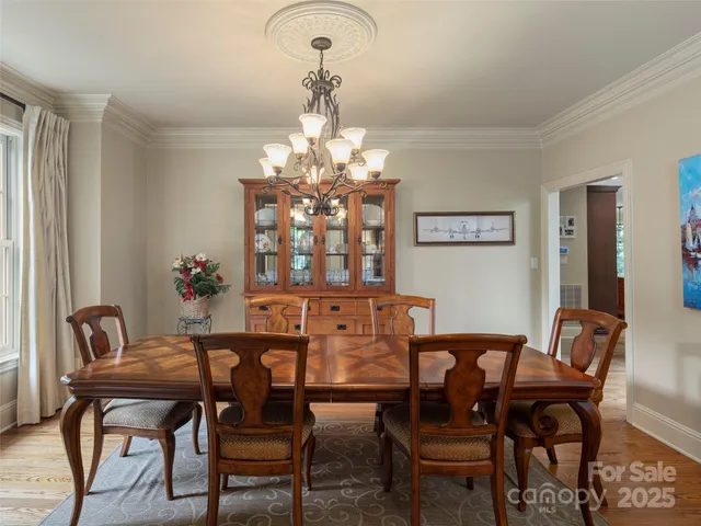 a view of a dining room with furniture and chandelier