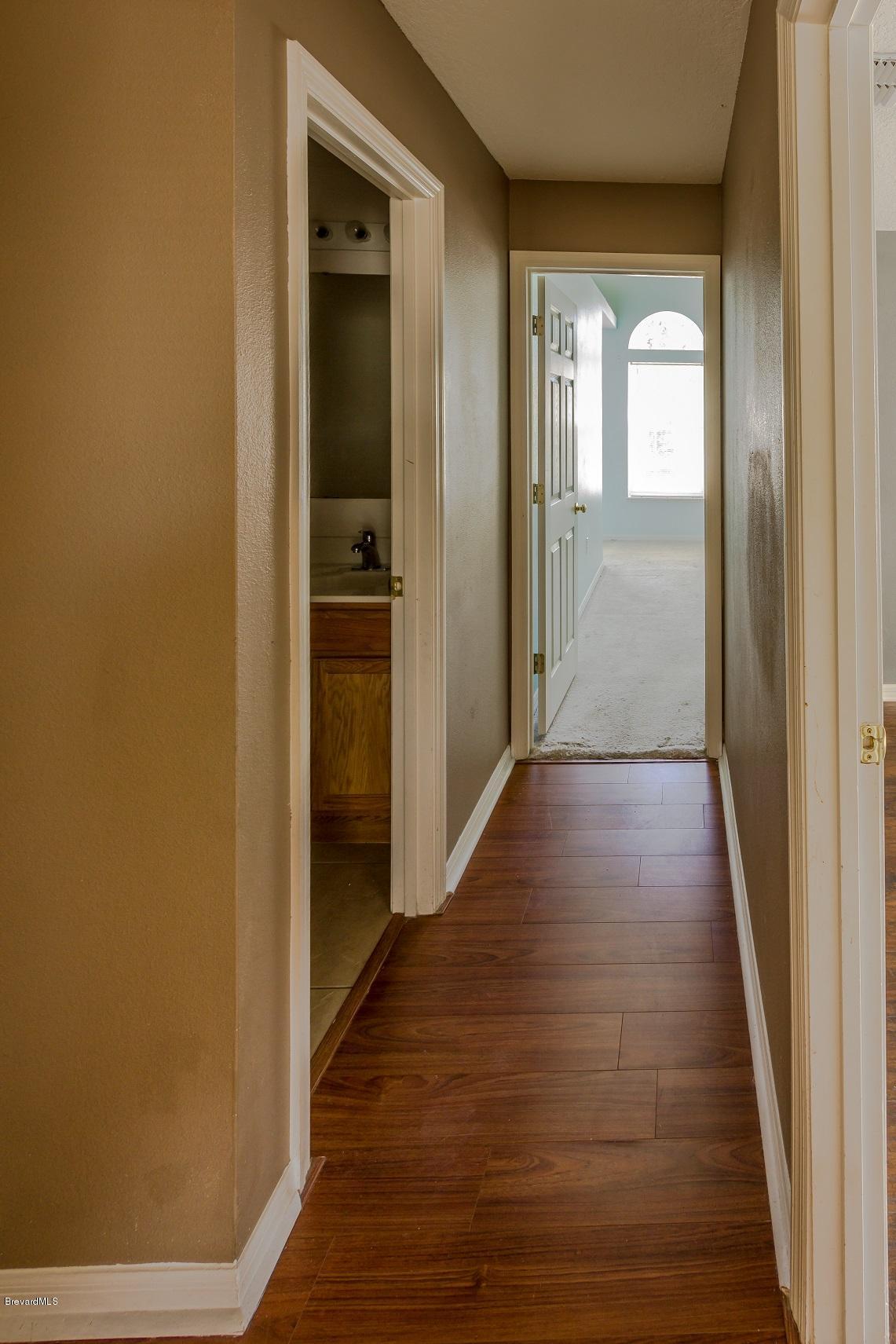 4785 Elena Way Melbourne, FL 32934 - Photo 13 of 19 Hallway to Master