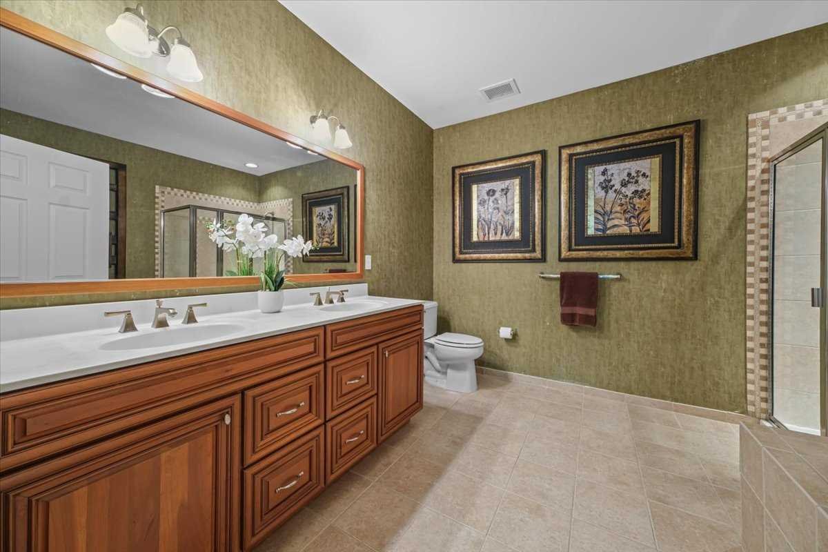 123 Regency Drive Fishkill, NY 12524 - Photo 18 of 28 a spacious bathroom with double vanity sinks a mirror and a lamp