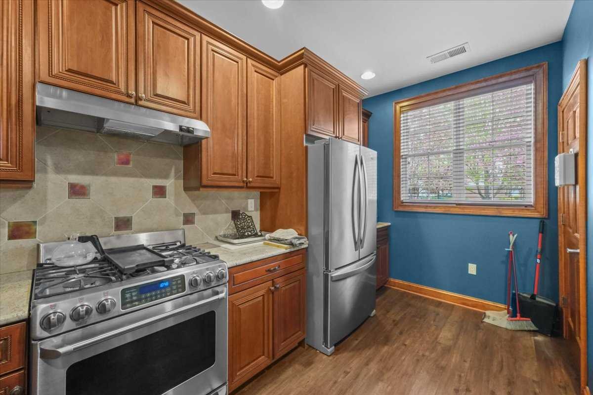 123 Regency Drive Fishkill, NY 12524 - Photo 27 of 28 a kitchen with stainless steel appliances granite countertop a stove a refrigerator and a cabinets