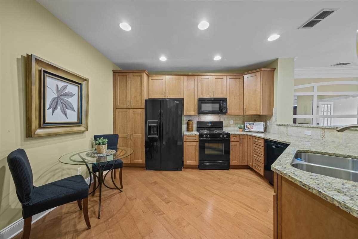 123 Regency Drive Fishkill, NY 12524 - Photo 6 of 28 a kitchen with stainless steel appliances granite countertop a refrigerator a sink a stove a dining table and chairs