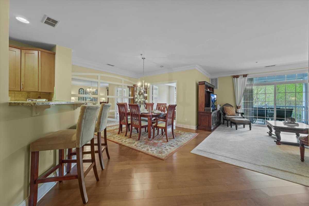 123 Regency Drive Fishkill, NY 12524 - Photo 7 of 28 a dining room with furniture a chandelier and wooden floor