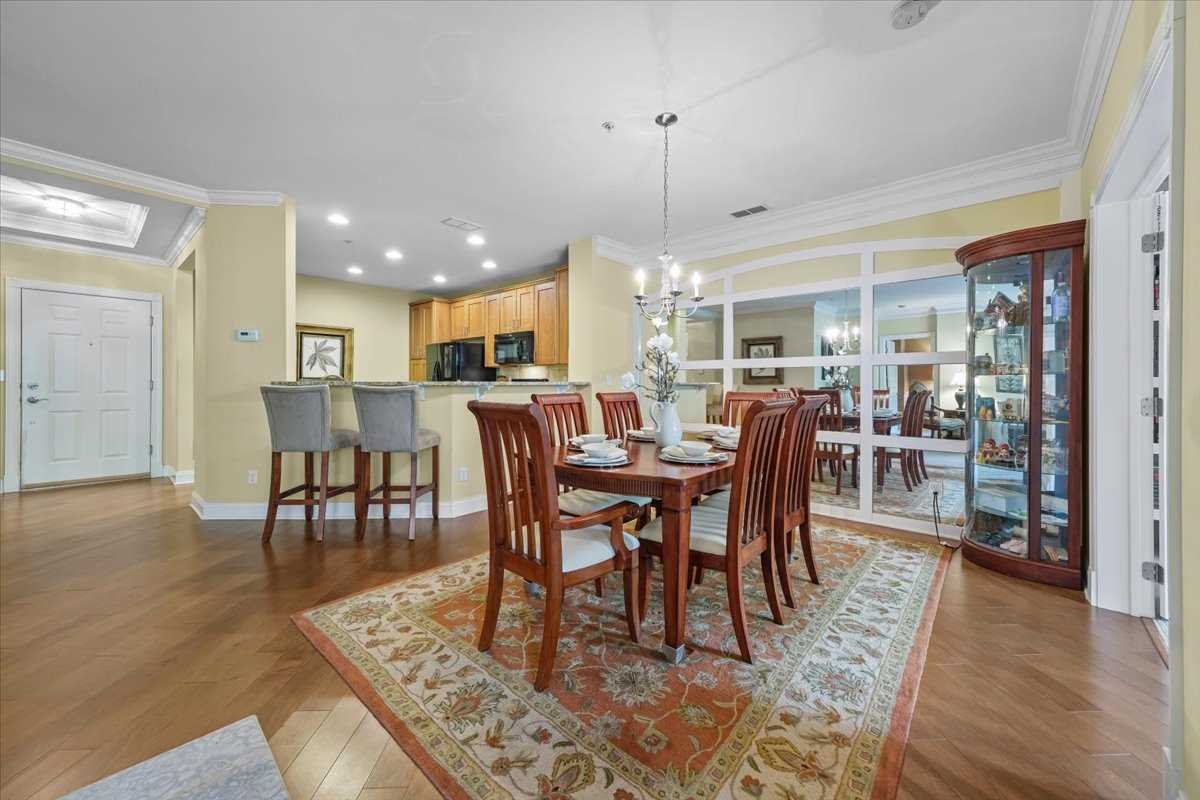 123 Regency Drive Fishkill, NY 12524 - Photo 8 of 28 a view of a dining room and livingroom with furniture wooden floor a rug and a chandelier