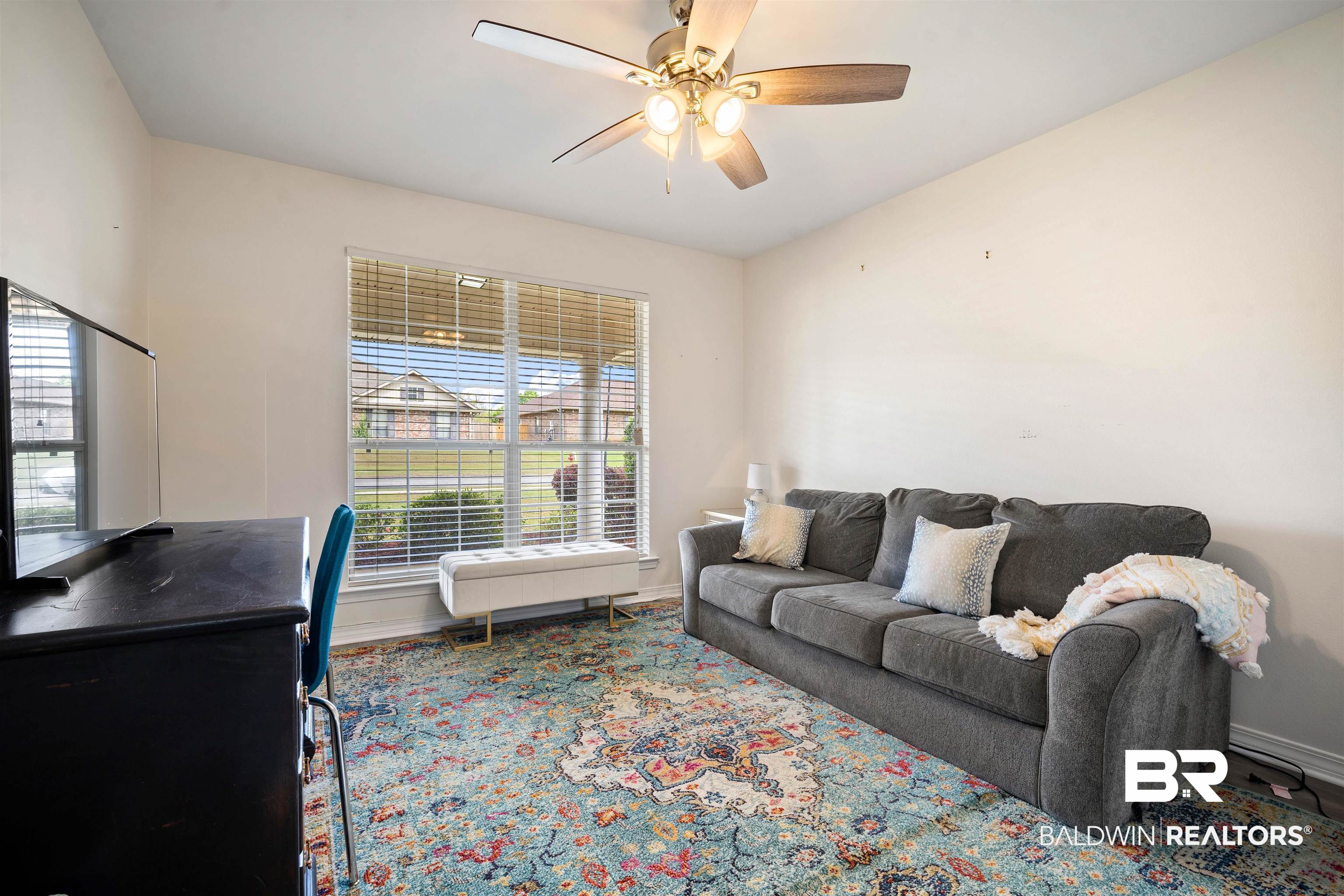 10713 Rigby Drive Mobile, AL 36695 - Photo 22 of 35 Living area featuring baseboards and ceiling fan