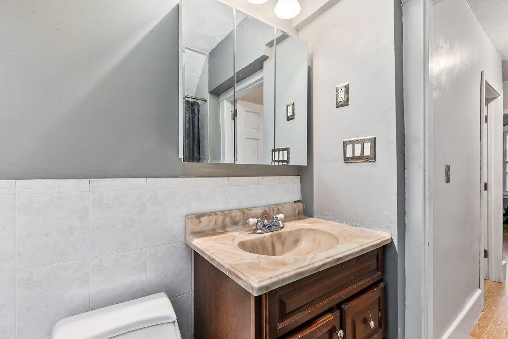 44 Wright Street Stoneham, MA 02180 - Photo 11 of 38 a bathroom with a sink and a toilet