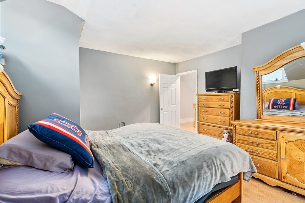 44 Wright Street Stoneham, MA 02180 - Photo 12 of 38 a bedroom with a bed and a flat screen tv