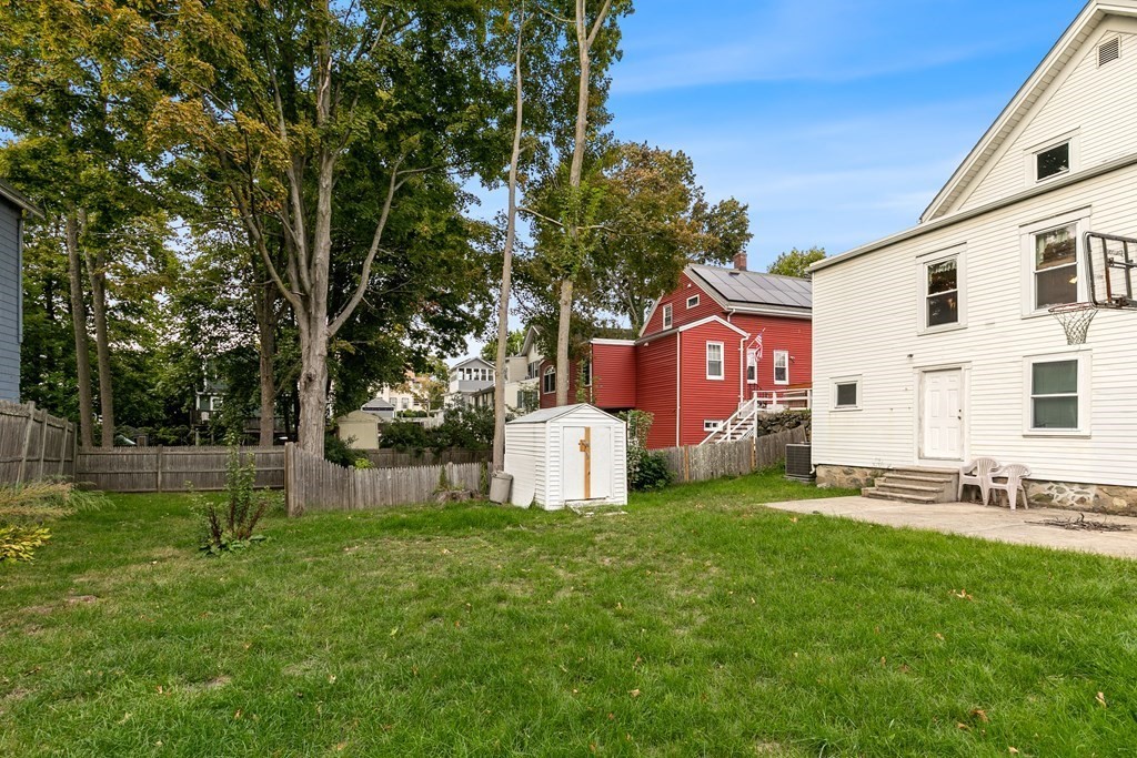 44 Wright Street Stoneham, MA 02180 - Photo 14 of 38 a view of a house with a yard