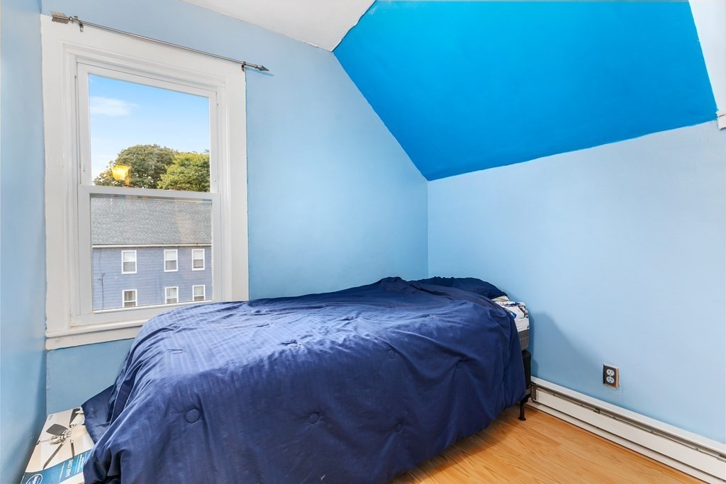 44 Wright Street Stoneham, MA 02180 - Photo 15 of 38 a bed sitting in a bedroom next to a window