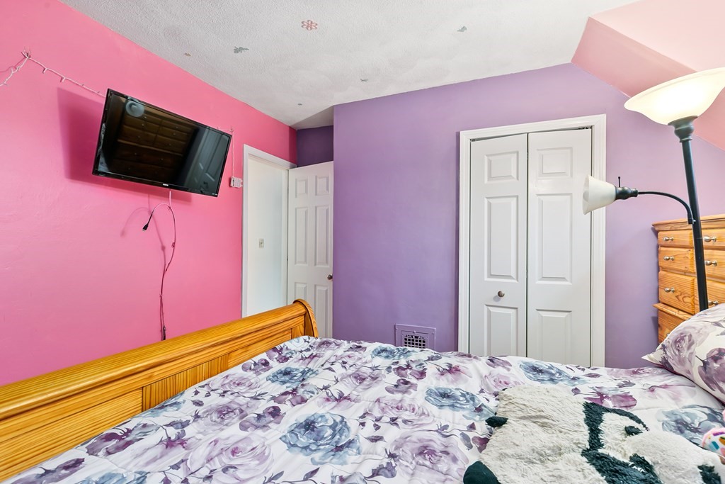 44 Wright Street Stoneham, MA 02180 - Photo 25 of 38 a bedroom with a bed and a flat screen tv