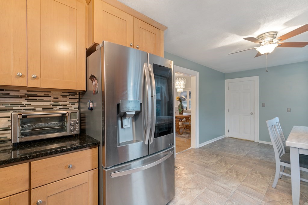 44 Wright Street Stoneham, MA 02180 - Photo 32 of 38 a kitchen with stainless steel appliances granite countertop a refrigerator and a stove