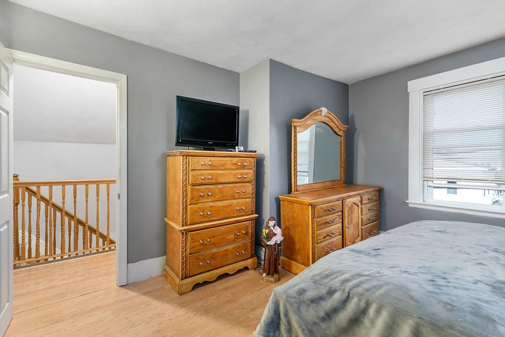 44 Wright Street Stoneham, MA 02180 - Photo 35 of 38 a bedroom with a bed and a flat tv screen on dresser