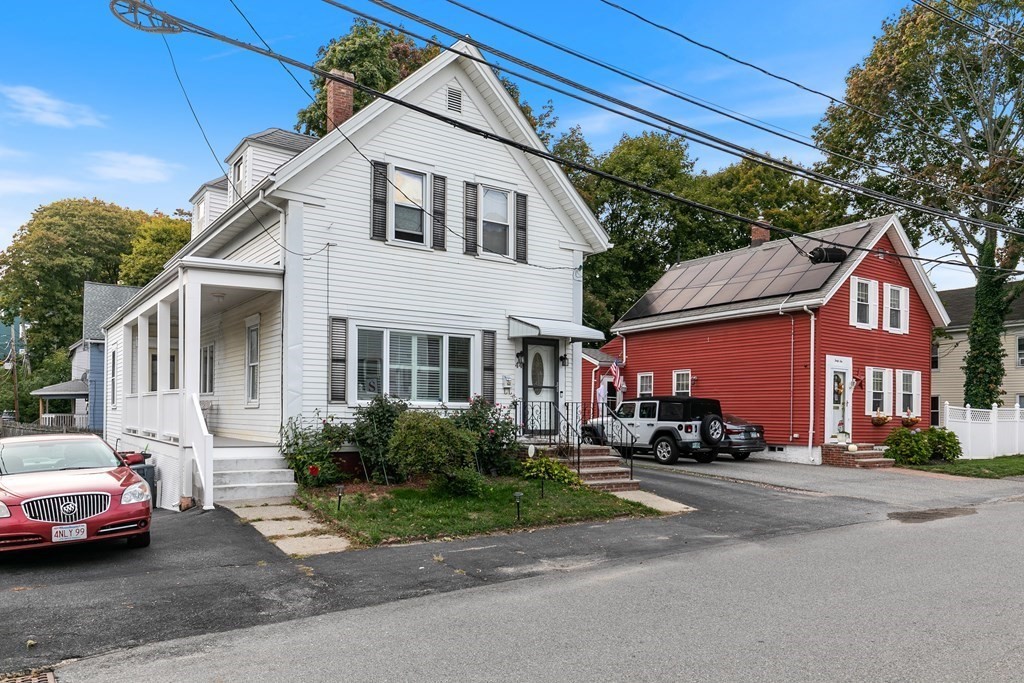 44 Wright Street Stoneham, MA 02180 - Photo 4 of 38 a front view of a building with cars parked