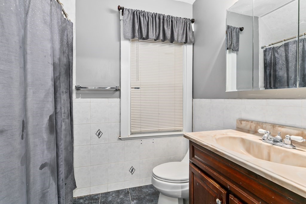 44 Wright Street Stoneham, MA 02180 - Photo 9 of 38 a bathroom with a sink toilet and shower